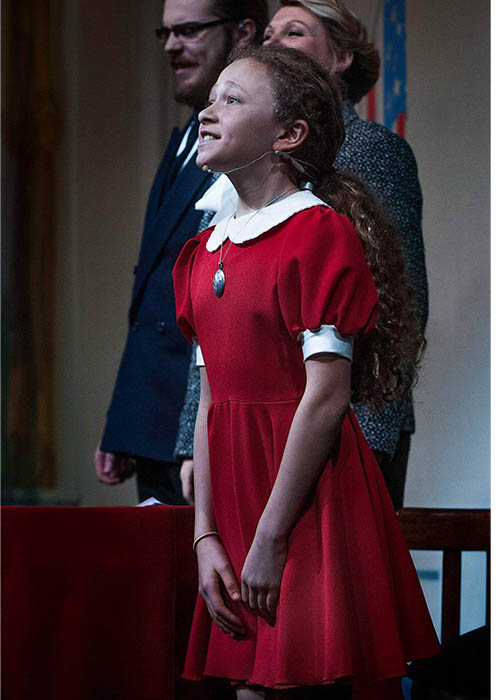 Annie at Mr Warbucks&apos; house in red dress